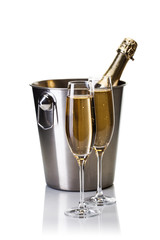 Champagne bottle in bucket with glasses of champagne