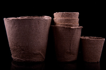 peat pots for seedlings on a black background
