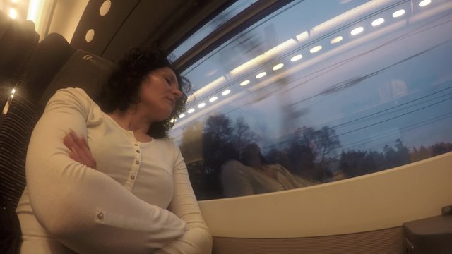Woman looks out of window on train 