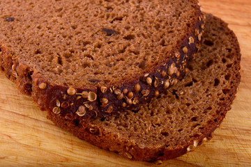 appetizing fresh slices of black bread with coriander seeds on a