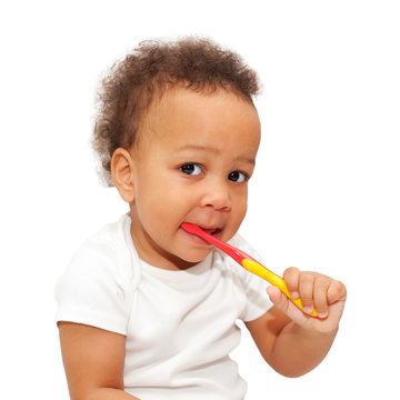 black baby brushing teeth.