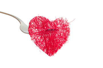 red heart strung on a fork separately on a white