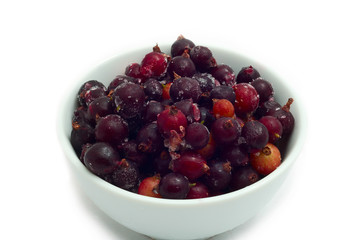 frozen currants in a saucer separate on white