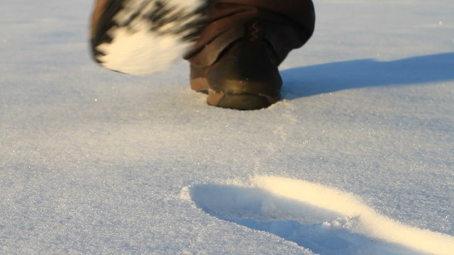 Man makes a shoeprint on the snow