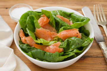 salad with smoked fish on white bowl
