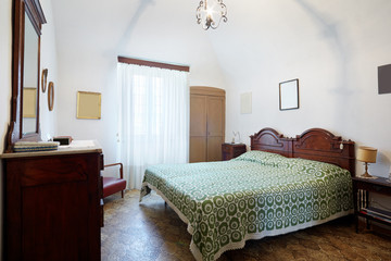 Old bedroom with queen double bed in ancient house