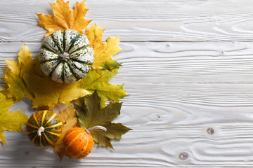 Autumn background with pumpkins and leaves