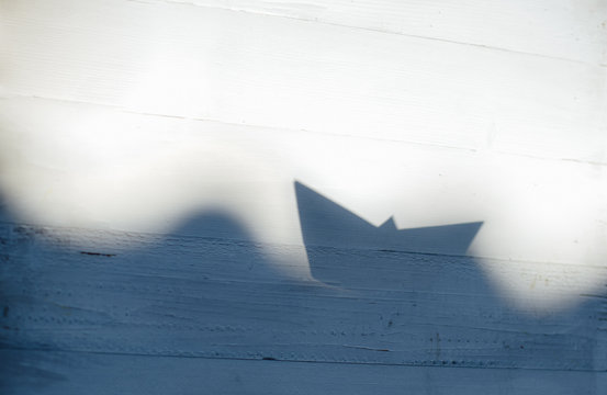 shadow origami boat on the waves