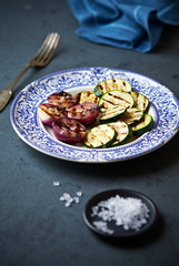 Grilled zucchini and red onion on a plate