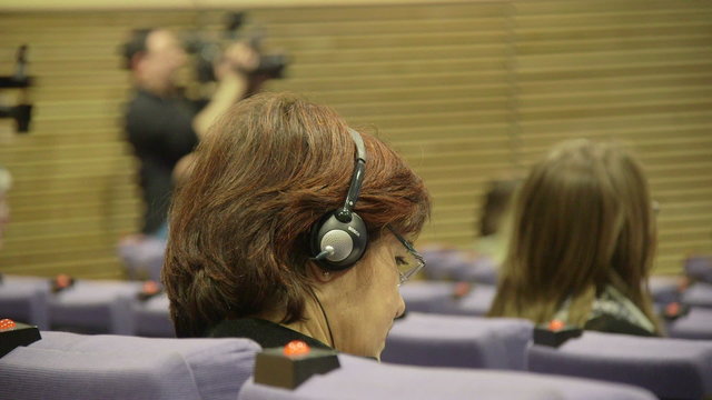 Journalist with headphones at press conference