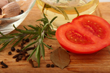oil with spices and tomato on the board