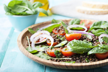 Lentil salad with cherry tomatoes, red onion and baby spinach.