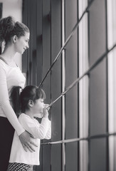 Two girls stare in a window