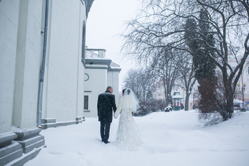 Bride and groom walking in the snow