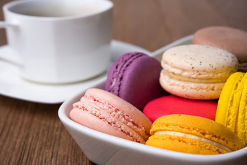 mix macaron on the wooden table with coffee