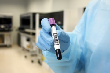 Hand with test tube of blood