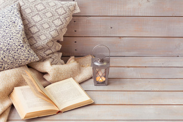 Christmas Lanterns and open book on wooden background.