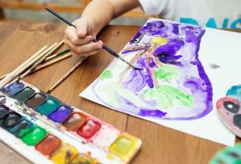 Child Painting at home, close up photo