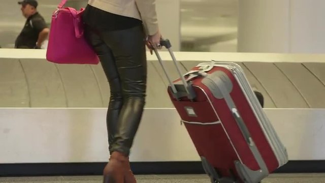 Passengers with luggage by airport caroussel