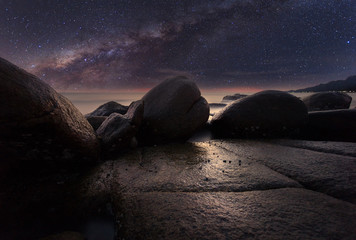 The stone beach under starry night clearly with milky way