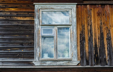 Wooden box with a white frame is located in an old wooden house.