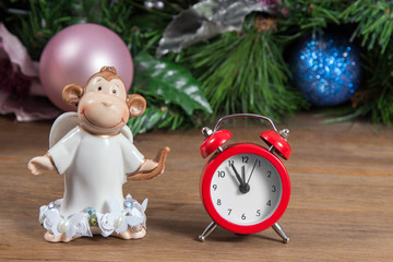 New Year composition with a ceramic monkey and alarm clock