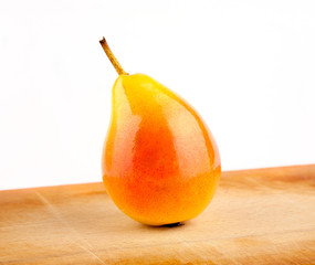 Glossy pear on wooden table