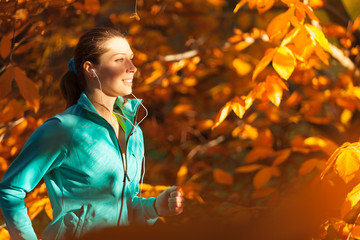 Female fitness model training outside and running.