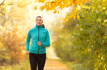 Female fitness model training outside and running.