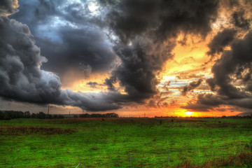 dramatic sky over a green field