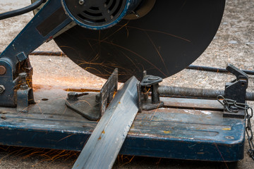 Cutting a triangle metal and steel with compound mitre saw with circular blade