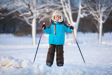 Cute little boy having fun during skiing on cross