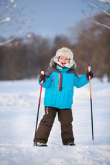 Cute little boy having fun during skiing on cross