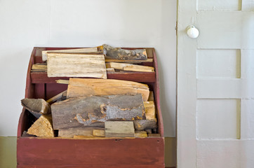 Old Wood Box Holding Firewood Beside Door in House