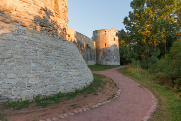 Under the walls of the ancient fortress in Izborsk in the summer evening
