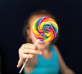 Ginger girl holding a sweet lollipop