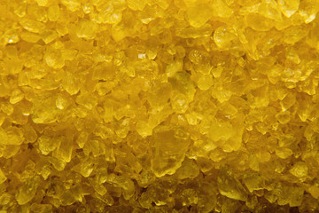 Naklejka na ściany i meble Texture of yellow salt. Yellow salt background.