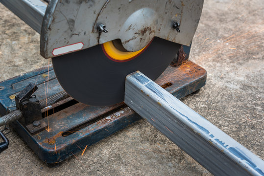 Cutting a square metal and steel with compound mitre saw with cicular blade