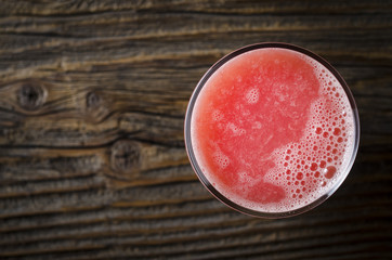 Grapefruit juice over wooden table