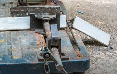 A triangle metal and steel with compound mitre saw with circular blade