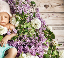 Cute child sleeping on the flowers