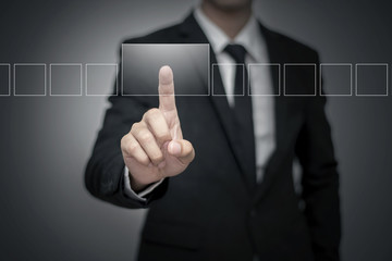 Close up of businessman touching digital screen with finger