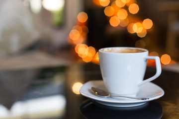 Hot art Latte Coffee in a cup on table and Coffee shop blur back