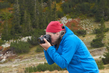 hiking man in nature taking photo