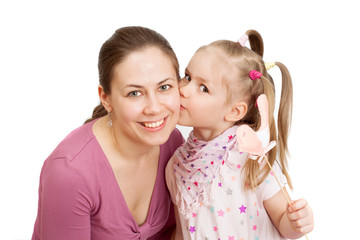 a little girl is kissing a happy mom