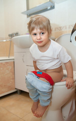  girl sitting on   toilet bowl