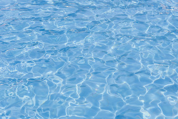 Fototapeta na wymiar blue swimming pool with sunny reflections