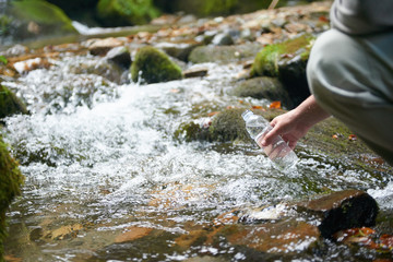 man drinking fresh water from spring