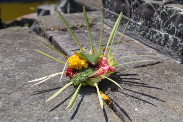 Traditional balinese offerings to gods in Bali with  flowers