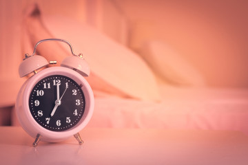 alarm clock on the bed in bedroom, retro style